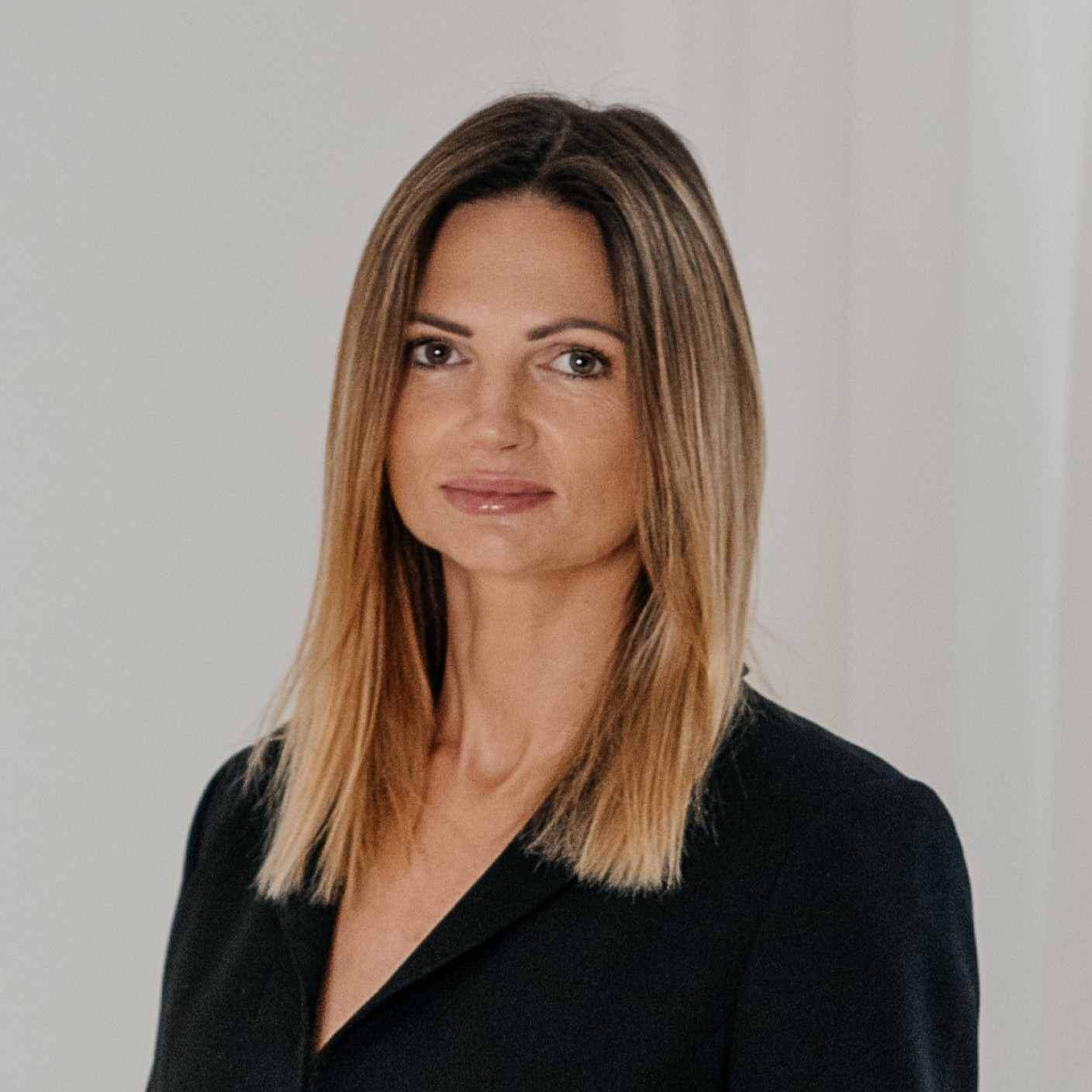 Portrait photo &ndash; a woman with straight blond hair and a neutral expression, wearing a dark jacket. She is looking directly at the camera. The photo introduces Dr. Sigita Urbaitė, team member of KTU numerical simulation competence centre.